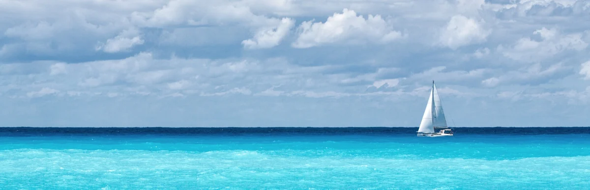 Sailboat crossing bright blue water, imagery featured by Keim Financial Group